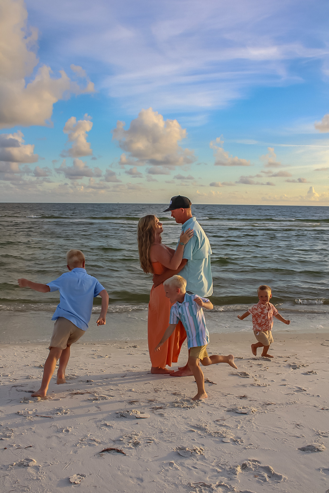 Family playing together at the shoreline during a Mexico Beach portrait session