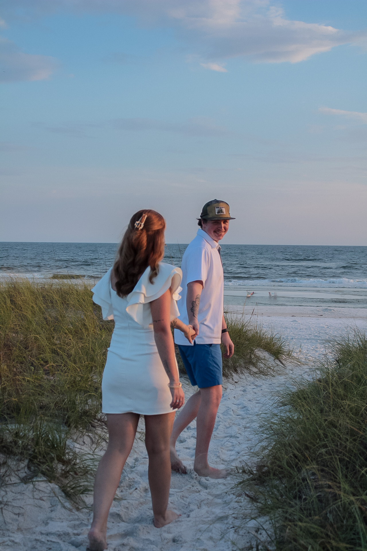 Young girl walking a coastal boardwalk before a beach portrait session