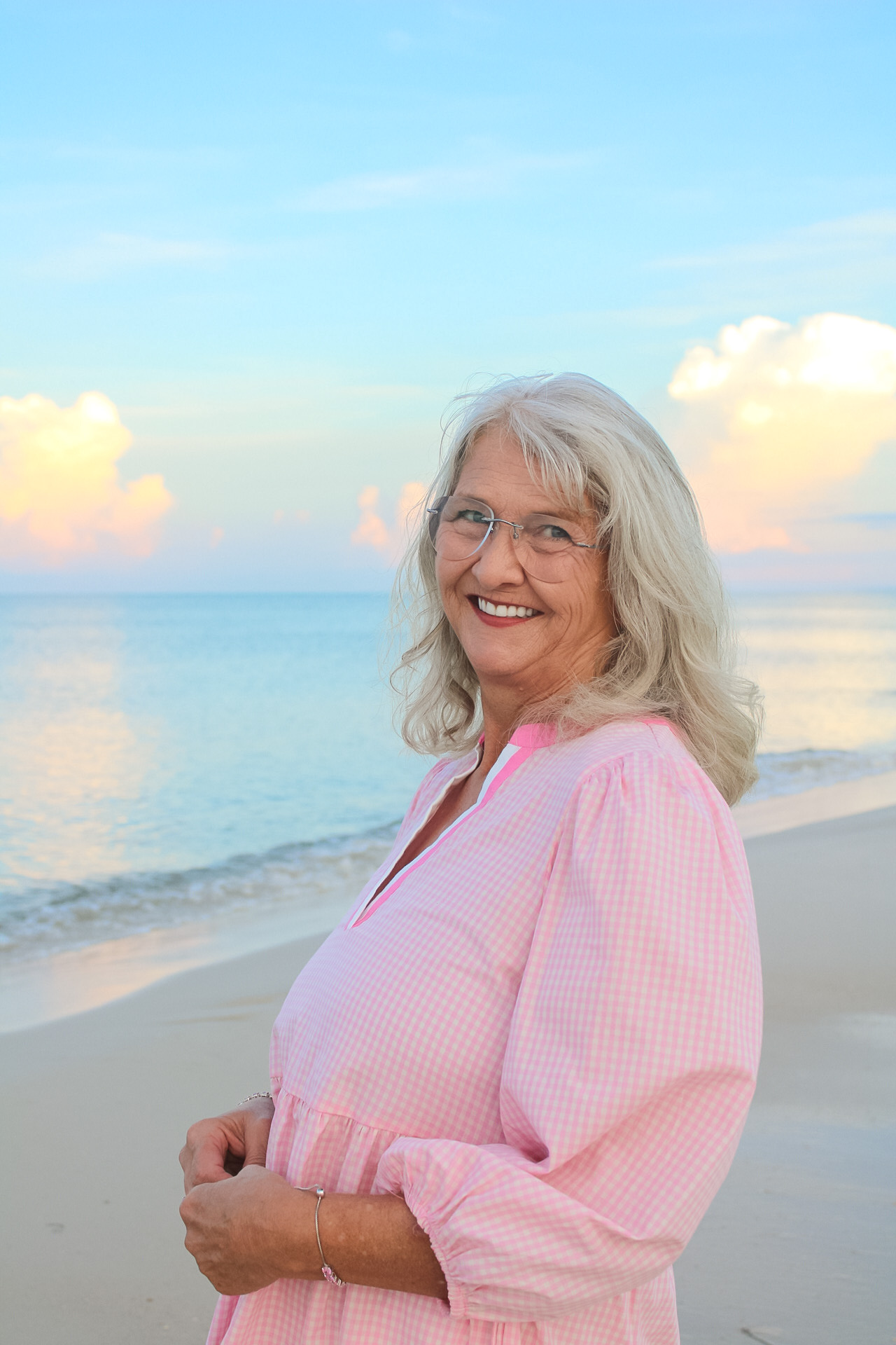 Senior woman smiling during a softly lit Gulf Coast beach portrait